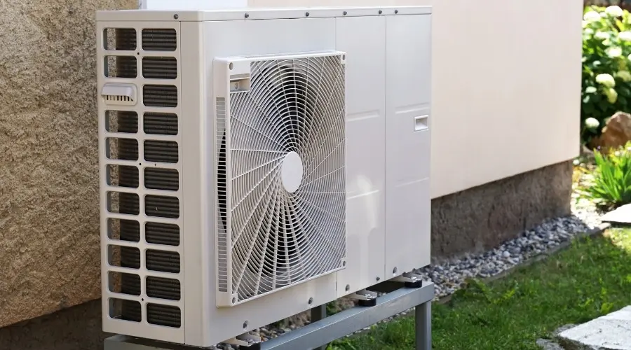 Modern heat pump unit installed outdoors, showcasing energy-efficient heating and cooling technology, relevant to home comfort solutions.