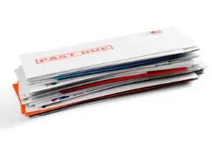 Stack of overdue bills emphasizing financial obligations and the importance of timely payments for maintaining home comfort and HVAC services.