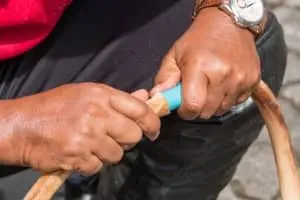 Person repairing a plumbing hose, demonstrating hands-on plumbing service expertise for The Meridian Company's plumbing resources.