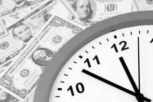 Clock showing time with U.S. dollar bills in the background, symbolizing the relationship between time and money in HVAC service efficiency.