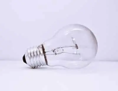 Light bulb on a white background, symbolizing the importance of choosing the correct wattage and type to prevent electrical hazards in older homes.
