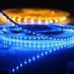 LED light strips on spools, showcasing bright blue and yellow hues for home decoration and HVAC ambiance enhancement.