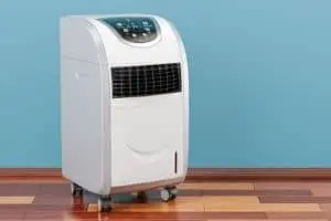 Portable air conditioner unit on wheels in a modern interior setting, emphasizing home cooling solutions and HVAC options.