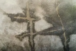 Cracked concrete foundation showing signs of water damage, highlighting potential foundation leak issues relevant to home plumbing concerns.