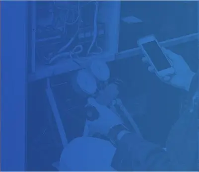 Technician using a smartphone while checking HVAC gauges, emphasizing air conditioning and heating repair services by Crowe's Comfort Solutions in Pooler, GA.