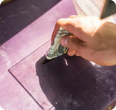 Person donating money with a dollar bill for Maxwell-White Plumbing's community food drive supporting local families in need.