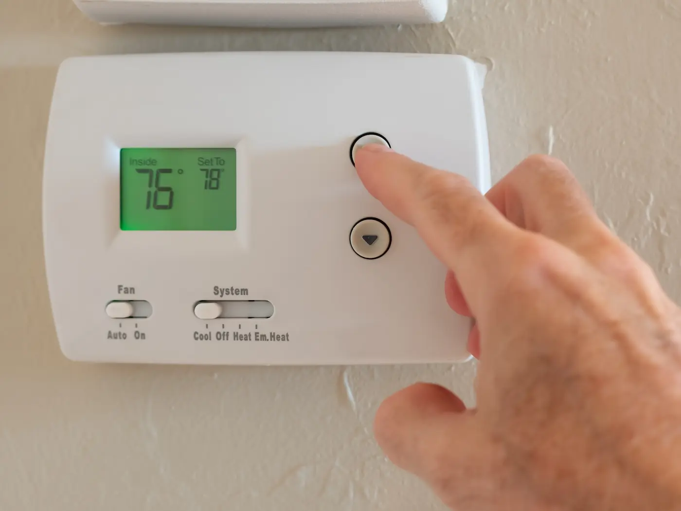 Setting digital thermostat to cool and programming air conditioning to energy saving temperature of 78 degrees.