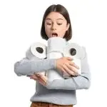 Surprised young woman with toilet paper rolls, representing Quahog Plumbing’s playful take on home essentials.