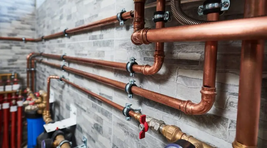 Installation of copper plumbing pipes with valves and fittings for efficient plumbing services by Quahog Plumbing.