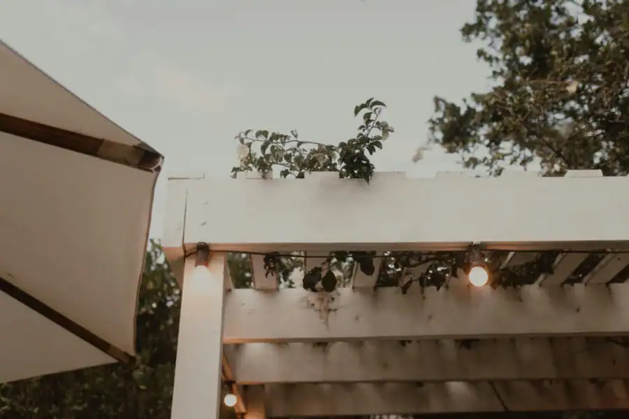 Backyard pergola with string lights and outdoor seating for entertaining