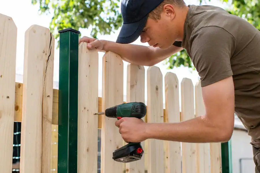 man installing fence