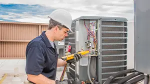 HVAC technician repairing heat pump system, JD Precision Plumbing & Air