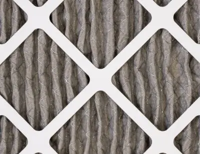 Fiberglass air conditioning filter showing pleated design, highlighting its structure for trapping airborne particles like pollen and dust, relevant for allergy management in HVAC systems.