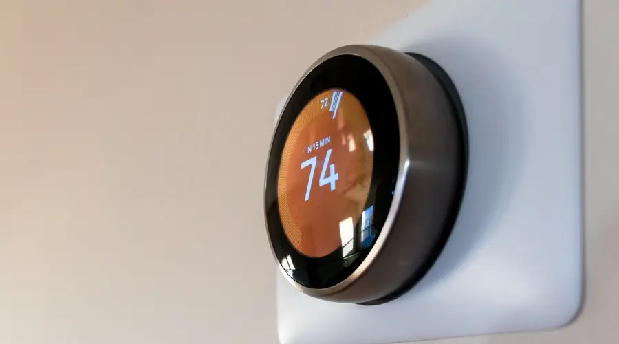 Smart thermostat displaying temperature settings for efficient heating and cooling management.