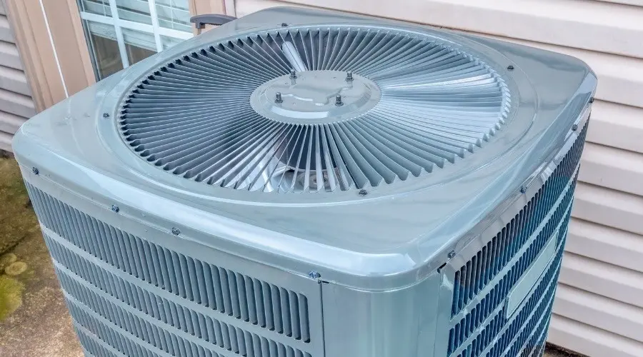 Exterior air conditioning unit and signs of AC replacement needed.