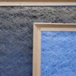 Textured surface in blue and gray with a wooden frame outlining a blue section, relevant for HVAC filter advice.