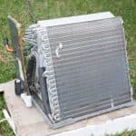 Air conditioning unit with metal coils in outdoor setting, showcasing repair features for Jerry Brittingham A/C & Heat, Inc.