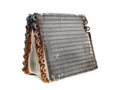 Evaporator coil showing buildup, crucial for air conditioner efficiency and cooling power, highlighting the importance of regular maintenance and cleaning for optimal HVAC performance.