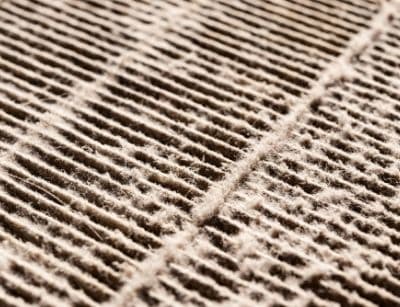 Close-up of a dirty air filter showing accumulated dust and debris, emphasizing the importance of regular air filter replacement for HVAC efficiency and indoor air quality.