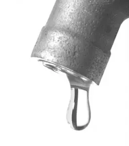 Dripping faucet emphasizing the importance of drain cleaning for effective plumbing maintenance.