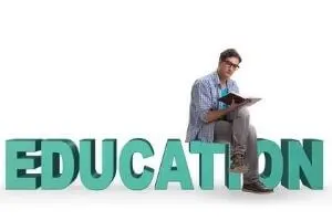 Man studying with a book next to large teal letters spelling "EDUCATION," symbolizing the importance of education for aspiring industrial plumbers.
