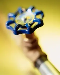 Gas valve handle for controlling gas flow, representing safety measures for gas line leak repairs, relevant to plumbing services and homeowner safety.