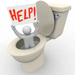 Alexandria Emergency Plumber Person in toilet holding "HELP!" sign, symbolizing urgent plumbing issue needing immediate assistance, relevant to emergency plumbing services in Falls Church, VA.