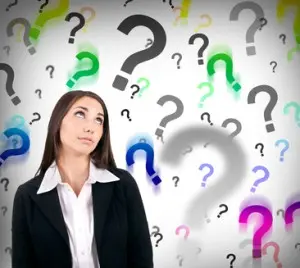 Businesswoman with question marks Woman in business attire looking up, surrounded by colorful question marks, symbolizing inquiries about trenchless sewer repair and replacement.