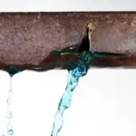 Burst pipe leaking water, highlighting potential plumbing emergency, relevant to preventive maintenance and emergency services by The Plumbing Dr.