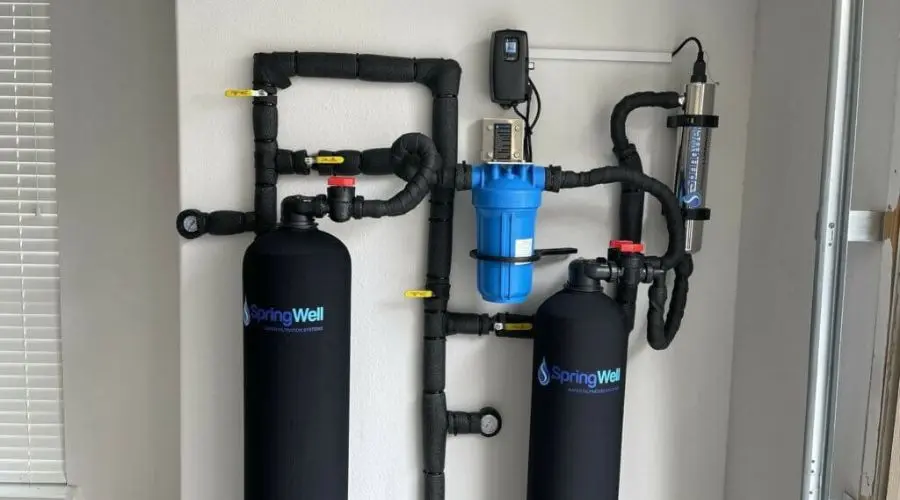 Water filtration system installation featuring two black tanks and a blue filter, emphasizing safe water solutions for homeowners in Falls Church, VA.