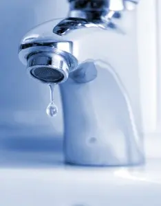 Arlington Leak Detection Faucet with a dripping water drop, highlighting the importance of leak detection services for preventing water damage in homes.