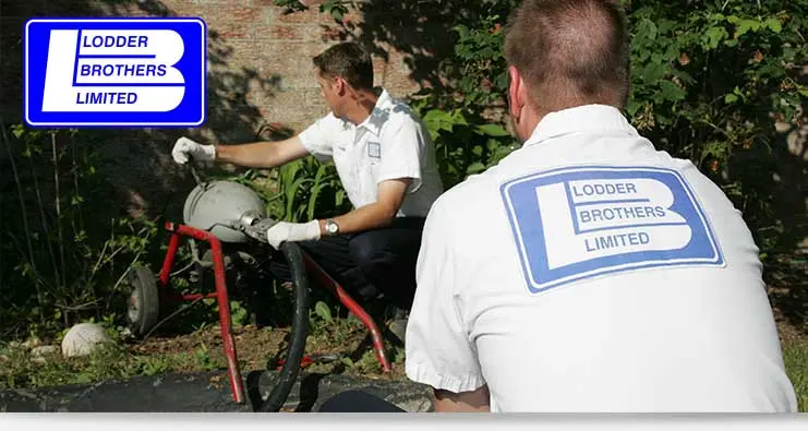 Technicians from Lodder Brothers Limited performing drain cleaning using hydrojetting equipment in Guelph, showcasing professional plumbing services.