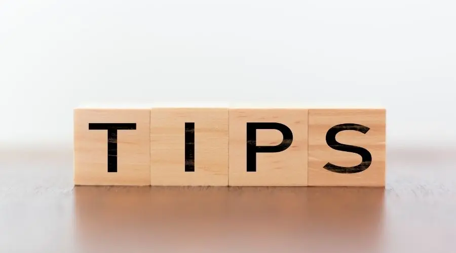 Wooden blocks spelling "TIPS," symbolizing advice and guidance related to plumbing solutions and eco-friendly practices.