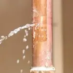 Copper pipe with water leakage indicating a plumbing issue for Charles Krull & Son, Inc. Plumbing & Heating services.