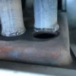 Rusted metal pipes on a worn surface, illustrating industrial decay for plumbing services by Charles Krull & Son, Inc.