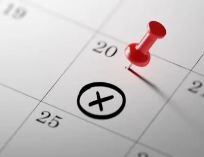 Red pushpin marking the 20th on a calendar with an 'X' circled, symbolizing scheduled maintenance reminders for home service plans.