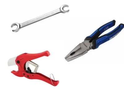 Hand tools used by plumbers, including a pipe cutter, adjustable wrench, and pliers, essential for DIY plumbing repairs and professional plumbing services.