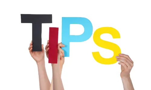 Hands holding colorful letters spelling "TIPS," emphasizing boiler maintenance advice for homeowners preparing for winter.