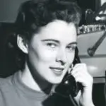 Vintage image of a woman with a classic telephone, reflecting Lillian Baumbach's pioneering spirit in plumbing.