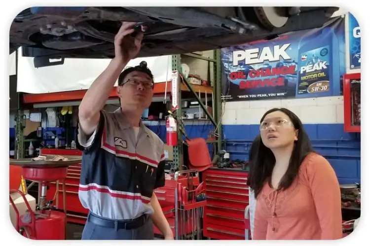 GIC Car Clinic Technician showing customer whats wrong with her car