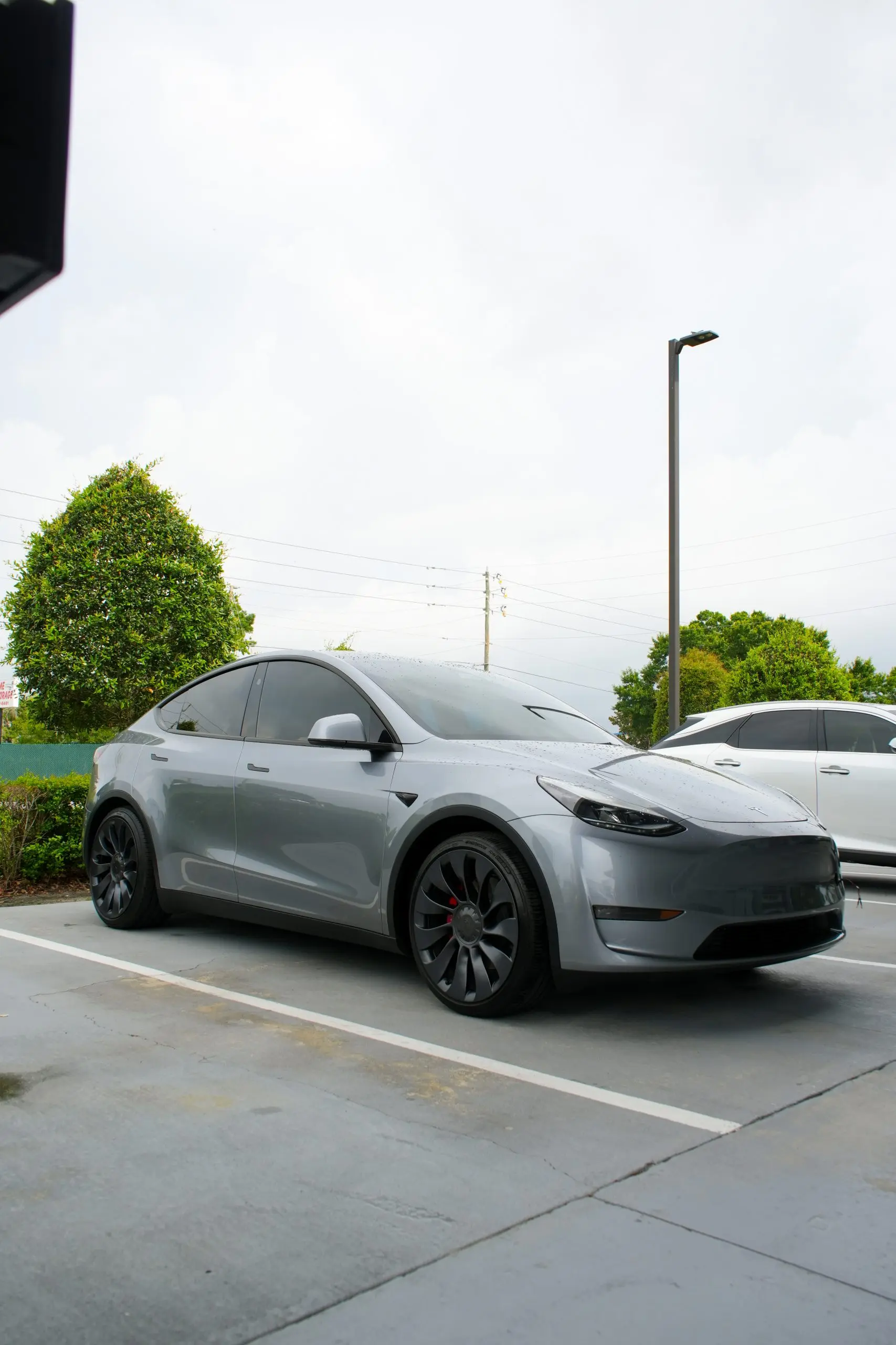 A grey Tesla Model Y that has received collision repair from windermere collision center