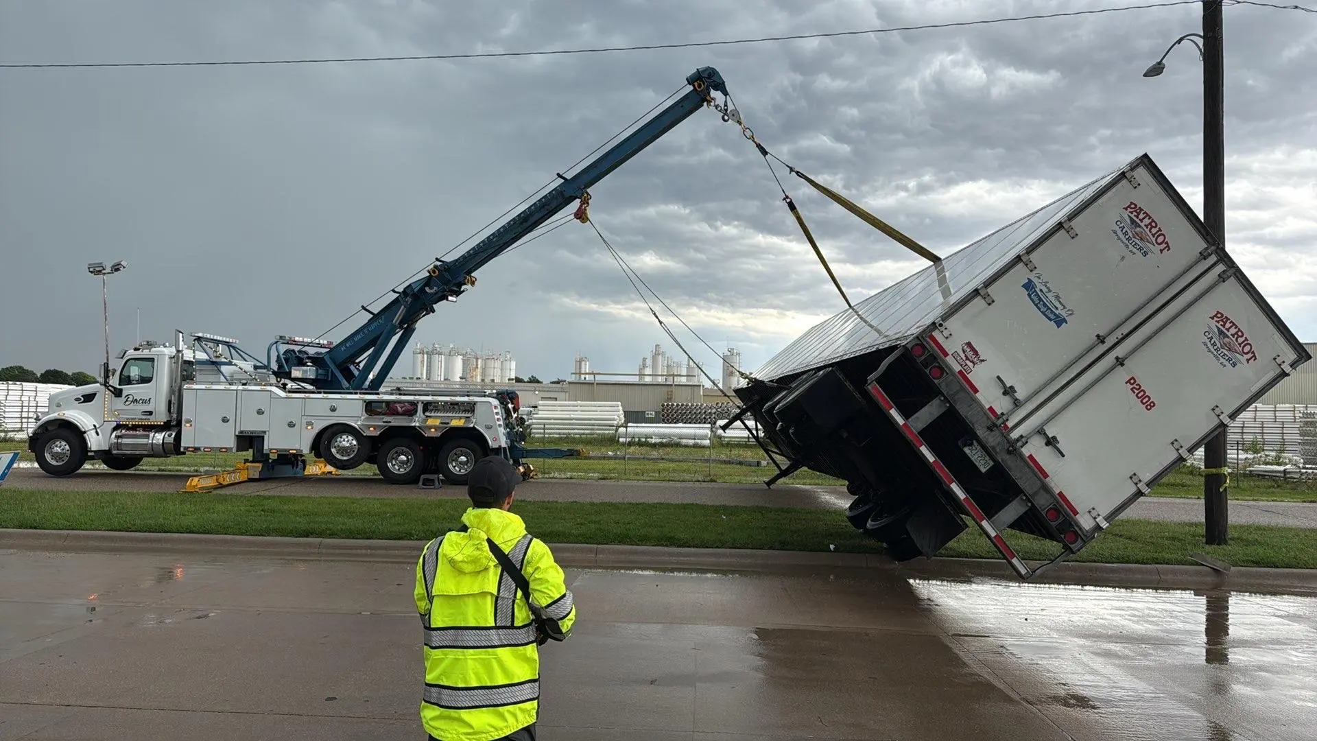 Heavy Recovery 854116493 a heavy-duty wrecker performing a recovery of a semi truck trailer that rolled over