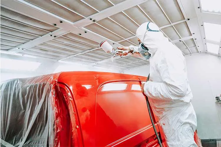 Professional auto painting being applied during vehicle restoration