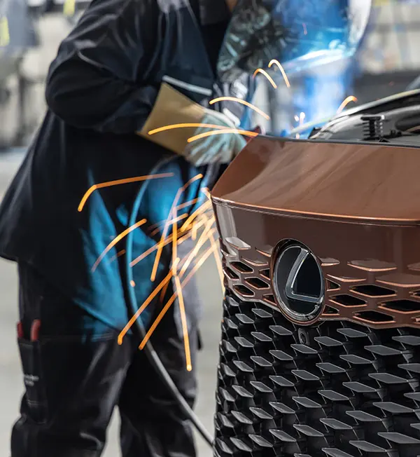 821 Collision technician welding a Lexus RX during certified collision repair