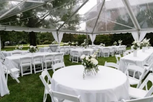 Wedding tables and chairs under tent rental for outdoor event in Elburn, IL.
