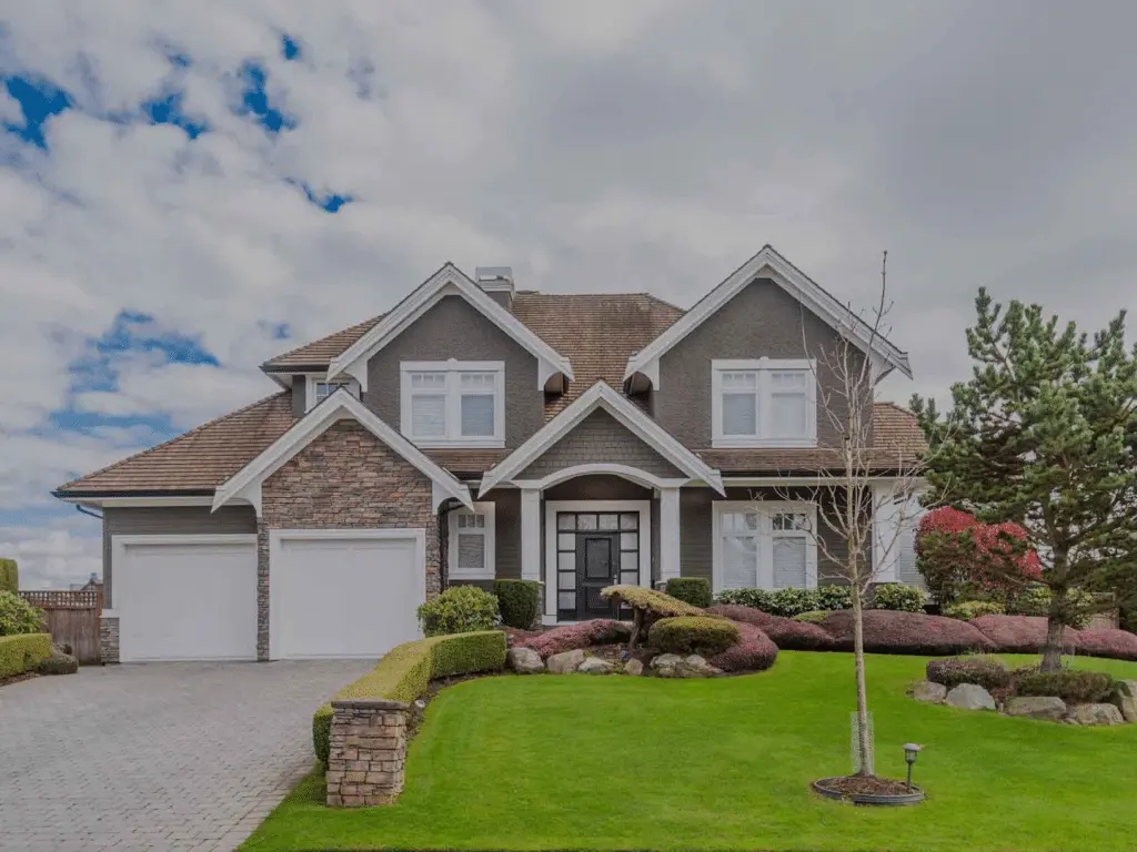 Modern residential home in Hopewell with landscaped yard, showcasing stone and siding exterior, double garage, and manicured gardens.