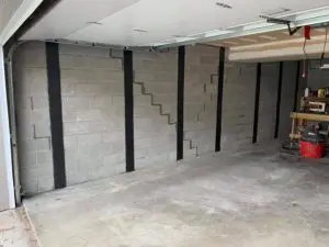 Carbon fiber straps installed to stabilize a bowing concrete block basement wall in PA or NJ