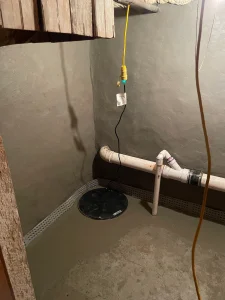 Sealed sump pump basin connected to interior French drain system in Philadelphia basement
