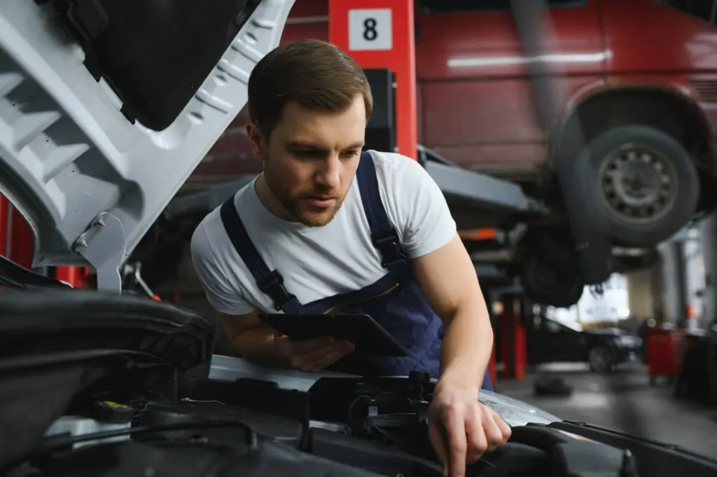 car mechanic using digital tablet with service
