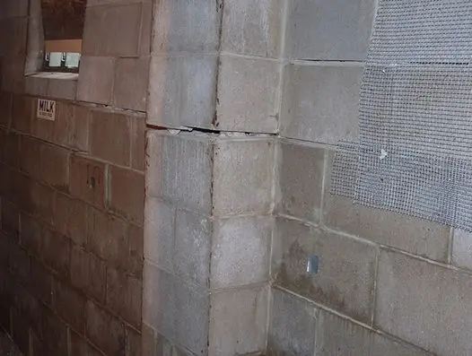 Bowing basement walls with horizontal cracking and inward displacement in a concrete block foundation